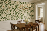 Southern magnolia wallpaper with a cream backdrop and green leaves, featuring a floral pattern.