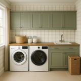 Plaid wallpaper with a grid pattern, accenting a laundry room with green cabinets and white appliances.
