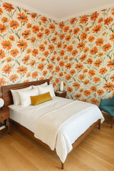 Sun-Kissed Tithonia wallpaper with orange flower pattern, covering bedroom walls in a bright, warm design.
