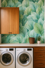 Green and blue Hosta Hush Wallpaper with large leaf pattern on the wall behind laundry appliances.