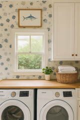 Floral confetti wallpaper with blue and gray blossoms, above a window with a framed print of a blue marlin.