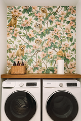 Blossom Scouts Wallpaper with a botanical pattern featuring dogs, against a light cream background.