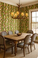 Cactus-themed wallpaper with red fruit details, in a dining room setting.
