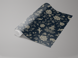 Rolled chinoiserie midnight wallpaper with floral and pagoda pattern on dark blue background.
