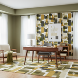 Retro geometric wallpaper in shades of olive and gold, with coordinating rug, white curtains, and mid-century modern furniture.
