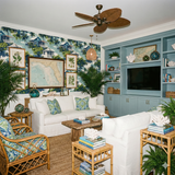 Scenic Conch House Reverie Wallpaper with houses and palms, decorating a coastal style living room.