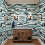 Loon Haven wallpaper with blue watercolor waves and loon pattern, covering a bathroom wall.
