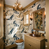 Patterned wallpaper featuring a dog design, with a rustic antler chandelier visible.