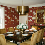 Crimson Helios wallpaper with floral and butterfly pattern, styled in a dining room setting.