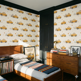 Yellow Cab Daydream Wallpaper with a taxi pattern against a cityscape background.
