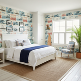 Boardwalk Ephemera Wallpaper with coastal town scene, collage design in a bedroom setting.