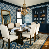 Blue and white patterned Saltaire Crest Wallpaper with a damask design, covering the walls of a dining room with dark trim.