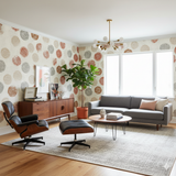 Patterned wallpaper with circular medallions, from Jaipur, covering a living room wall.
