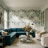 Crane patterned Fogbend Canopy Wallpaper from Anthropologie decorating a luxurious living room with blue sofa and cream chairs.
