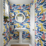 Regatta wallpaper with sailboat pattern in blue, yellow, and red, covering a bathroom wall.
