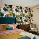 Floral wallpaper with painterly style by Chasing Paper, featuring pink, blue, and yellow flowers and leafy patterns.
