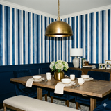 Blue and white striped wallpaper featuring vertical stripes with a textured appearance.