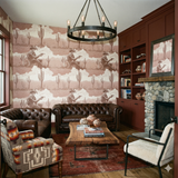 Sepia outlaw vista wallpaper featuring cowboy and cacti pattern, displayed on a wall in a living room.