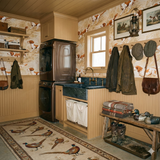 Redfern Chase Wallpaper with a dog pattern, covering the walls of a rustic laundry room.