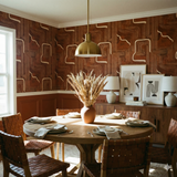 Brown patterned wallpaper from Redline Survey with tan geometric shapes.