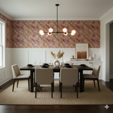Rosette Vale Wallpaper with a rose and gold swirling design, covering the upper wall above white panelling in a dining room.