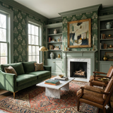 Green floral wallpaper by Hearthwood, covering the walls of a living room with built-in bookshelves.

