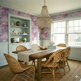 Rose Mirage wallpaper with a floral pattern, in a dining room setting, showing pink birds on a lavender background.
