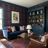 Neptune Nocturne wallpaper in a living room setting, featuring a bold floral and striped pattern.
