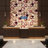 Bordeaux Echo wallpaper by Wallshoppe featuring a pattern of overlapping red and beige watercolor circles.