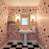 Pink Candy Arcade Wallpaper with retro geometric pattern, including triangles, circles, and squiggles.
