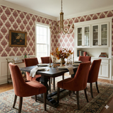 Cinnabar Vignette Wallpaper with a red floral pattern filling the wall in a dining room.