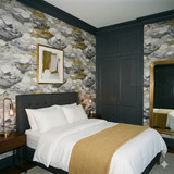 Clouded shore wallpaper with abstract clouds and gold accents, in a bedroom setting.

