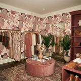 Floral wallpaper with woman design, no brand attribution, covering the walls of a stylish retail space.
