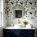 Terrazzo style wallpaper with a speckled pattern of teal, navy, gold and gray.