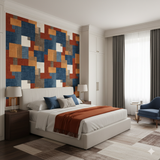 Claybourne Wallpaper with block pattern on a bedroom wall, above a bed with blue accent pillows.