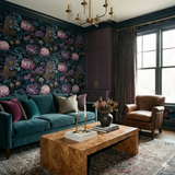 Floral wallpaper in purple and teal hues with dark green trim, visible in a styled room.
