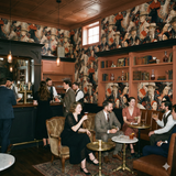 Rosethorne Kinship Wallpaper with a patterned design and portraits, paired with warm tones.
