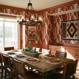 Red canyon wallpaper with brown and white rock patterns, decorating a dining room with southwest decor.
