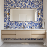 Blue and white floral wallpaper with tile-like pattern, featuring large rectangular mirror and wood vanity.