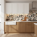 Red rock terrazzo wallpaper featuring a colorful aggregate pattern, displayed on a kitchen backsplash.