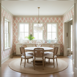 Coralhaven Wallpaper with coral branch pattern, on the walls of a dining room with windows and furniture.

