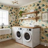 Bird patterned wallpaper with blue and gold accents, above white washing machines.
