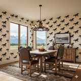 Patterned wallpaper by Black Mesa Run featuring horse silhouettes, in a room with wood furniture and large windows.
