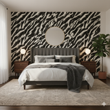 Black and white Cinder Stride Wallpaper with a zebra-like pattern, decorating a bedroom with a round mirror.
