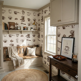 Cortado Atelier wallpaper with coffee-themed pattern, covering a cozy nook with bench seating and accent table.