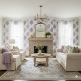 Lavender Haze Medallion Wallpaper with purple damask pattern, as seen on a living room wall.
