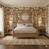 Floral wallpaper in a watercolor style with a pattern of pink and cream blossoms and foliage.