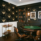 Patterned wallpaper by Flavor Paper with people playing poker at tables in a game room.