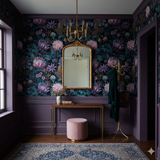 Floral wallpaper with purple and teal blooms, surrounding a gold mirror above a console table.