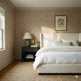 Willowdusk Sprigs wallpaper with white floral pattern on a neutral background, shown covering the walls of a bedroom interior.